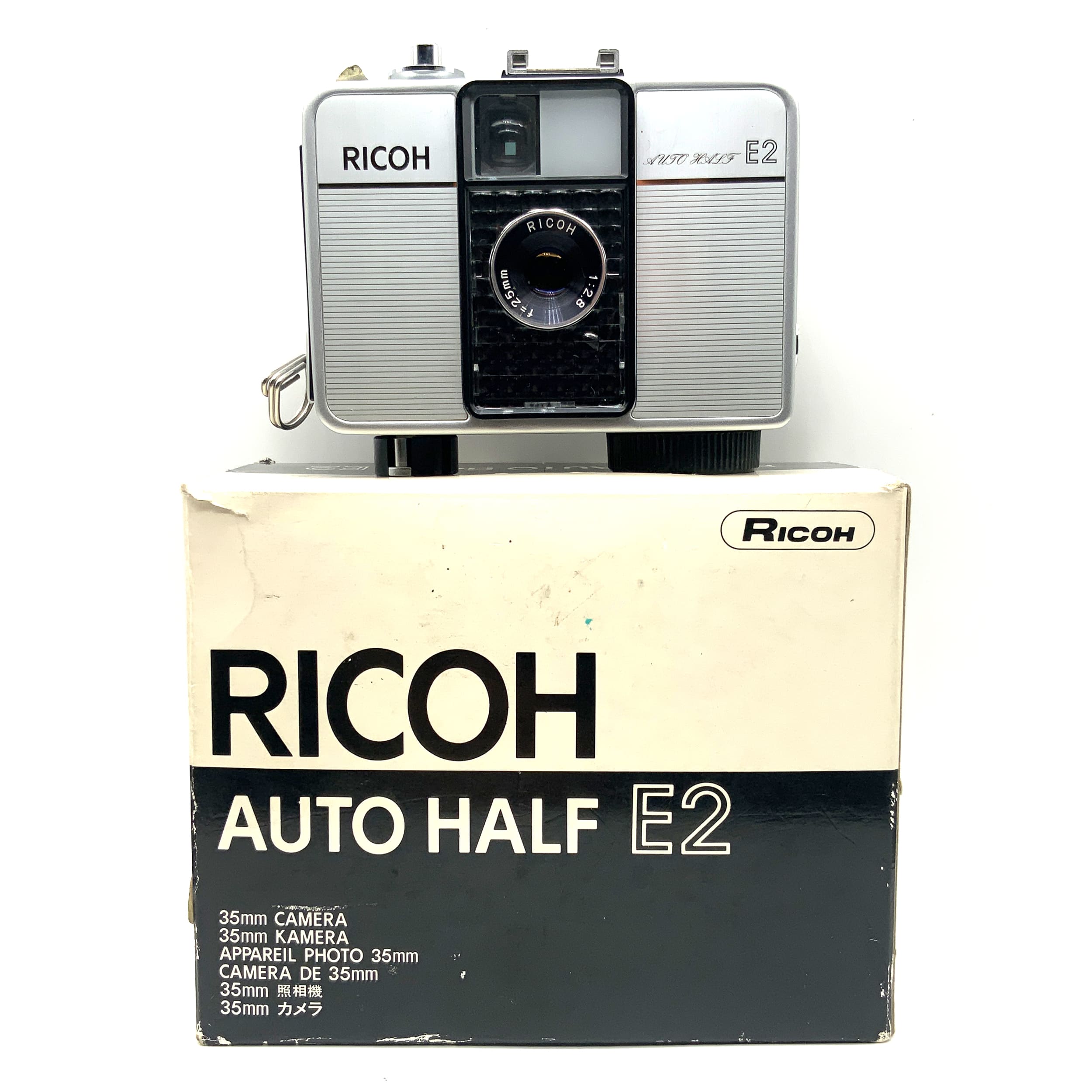 Ricoh Auto Half E2 viewfinder camera with f/2.8 f=25mm half-frame lens in original packaging, analog camera
